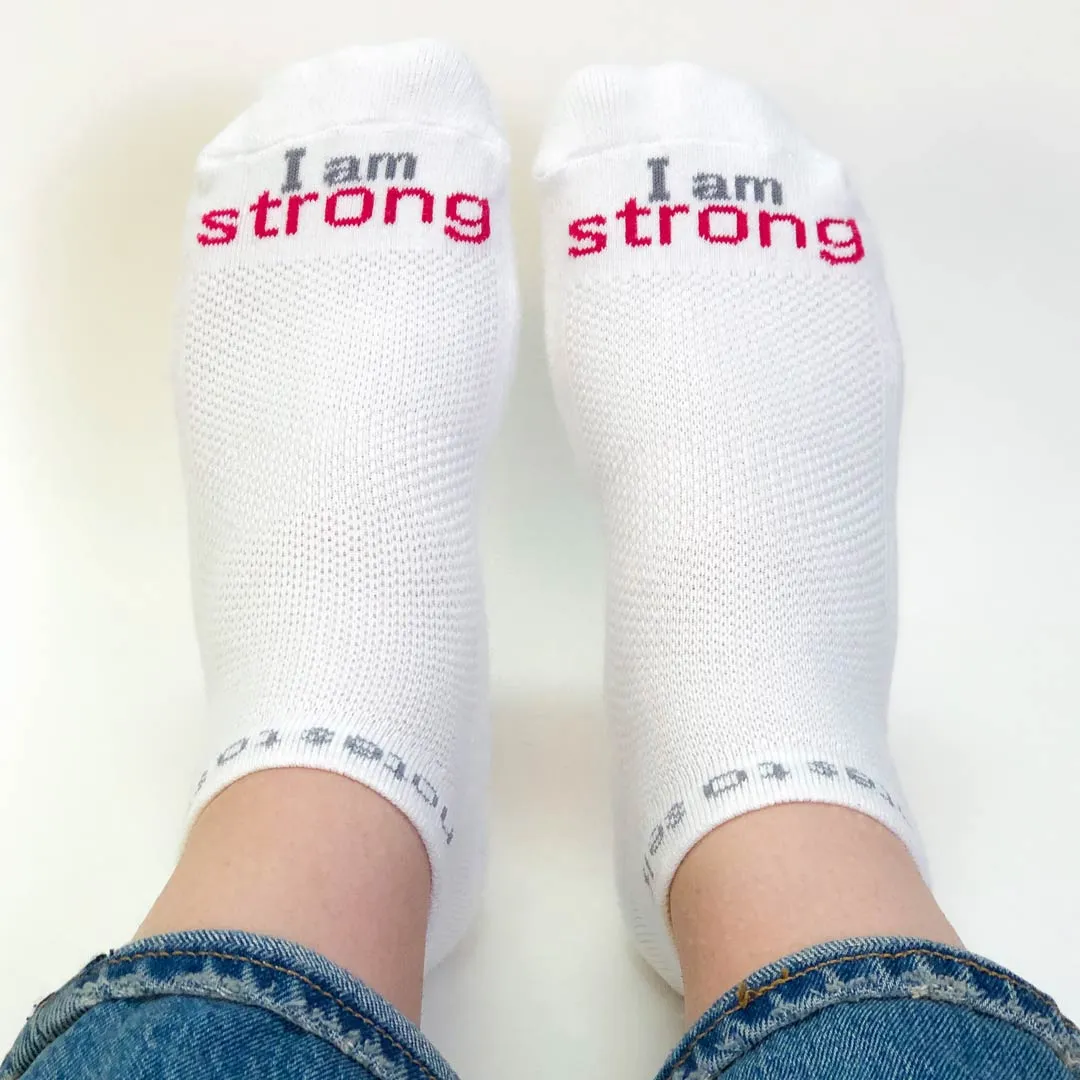 I am strong™ white low-cut socks with bold pink words